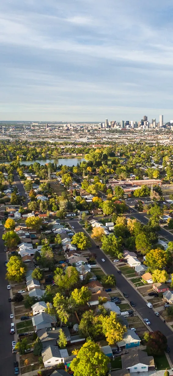 Aerial view of Denver neighborhoods with the downtown skyline