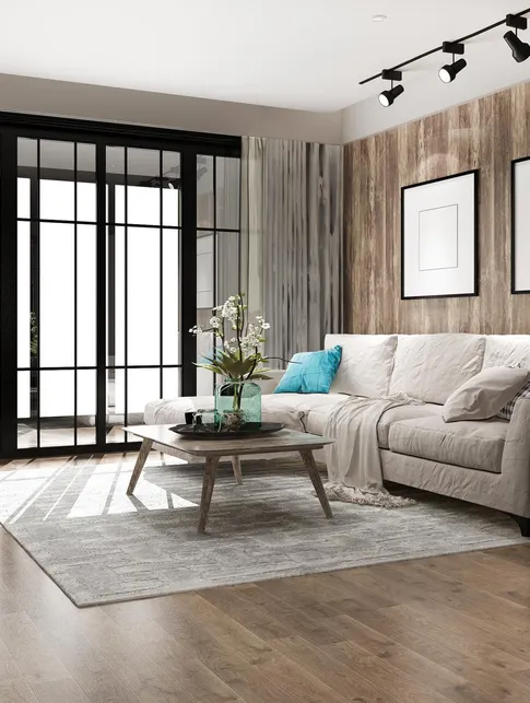 Bright, spotless living room with a grey sofa and wooden floors